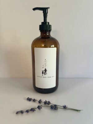 Amber glass with pump: Amber glass bottle with black push-down pump dispenser on a white background
